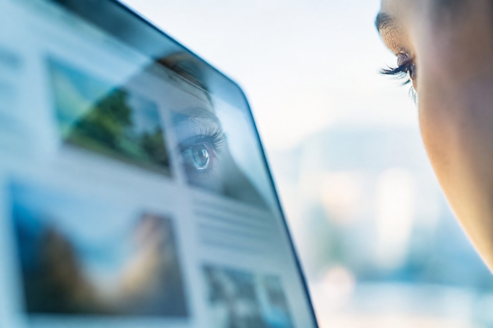 A close-up of an eye reflected in a tablet screen, evoking eye-tracking research
